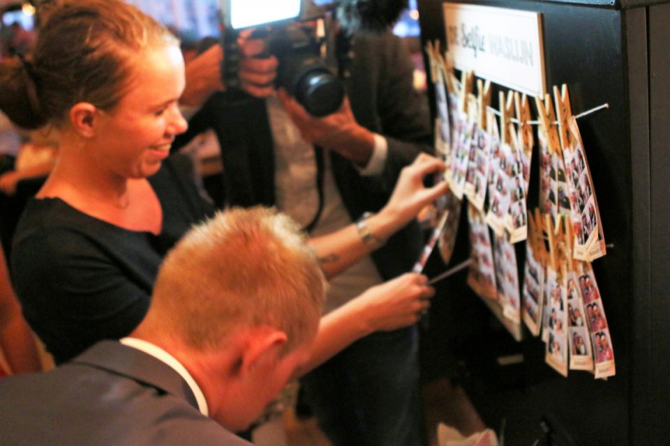 enclosed photobooth checking photos